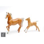 A Beswick Palomino (Prancing Arab Type), model 1261, oval mark together with a Beswick Palomino