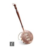 An Edwardian novelty calendar in the form of a miniature copper warming pan, turned handle and brass