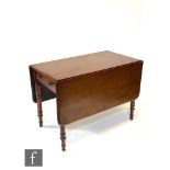 A 19th Century mahogany drop leaf dining table, fitted with a frieze drawer above ring turned