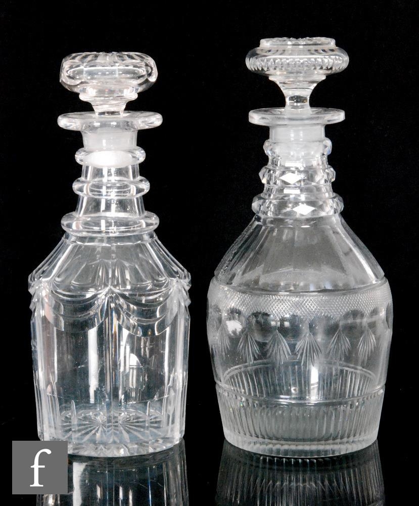 Two Georgian mallet form decanters, the first cut with swags and with basal slice cut decoration,