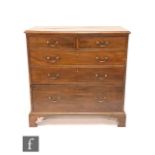 A George III mahogany straight front chest of two short and three long graduated drawers, brass swan