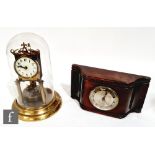 An Edwardian 365 day brass mantle clock in glass dome, circular Arabic dial, height 29cm, and a