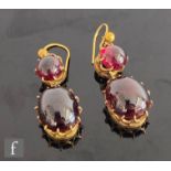 A pair of 19th Century 9ct garnet two stone drop earrings each comprising a cabachon cut circular