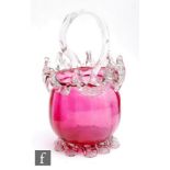 A 19th Century cranberry glass basket of ovoid form with applied pulled clear crystal decoration and