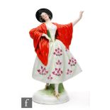 A 1930s German porcelain figure of a Spanish dancer dressed in a black hat, red shawl and floral