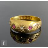 A 19th Century 18ct hallmarked gypsy set ruby and diamond three stone ring with fleur de lys