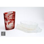 An early 20th Century Bohemian glass vase of compressed form, cased in ruby over clear and