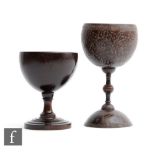 A 19th Century turned coconut cup on knop stem decorated with trailing leaf and berry design, height