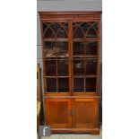 An early 20th century inlaid mahogany bookcase, the interior enclosed by a pair of arched bar glazed