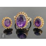 A 9ct hallmarked single stone amethyst ring, collar set oval stone, length 13.mm, within a rope