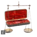 A set of George III apothecary pan scales with iron work cage suspension in fish skin red felt lined