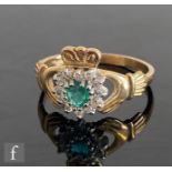 A 9ct hallmarked emerald and diamond set Claddagh ring, central emerald within a heart shaped border