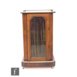 A small Victorian marquetry inlaid music or pier cabinet enclosed by a curtained glazed door below a
