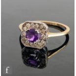 A 9ct hallmarked amethyst and diamond cluster ring, central claw set amethyst to a pave diamond
