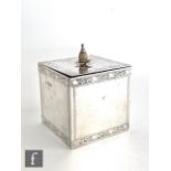 A hallmarked silver square sectioned tea caddy of plain form with bright cut engraved foliate