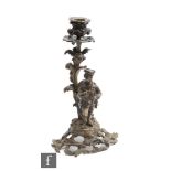 A 19th Century rococo style bronze candlestick mounted with a Regency dressed figure playing an