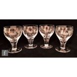 A set of four Stuart and Sons wine glasses in the Tamara pattern, the ovoid bowl decorated with a