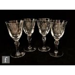 A set of four Stuart and Sons wine glasses in the Camelot pattern, the round funnel bowl decorated