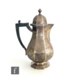 A hallmarked silver coffee pot of baluster panelled form and raised on a hexagonal stepped foot,