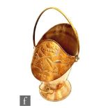 A continental Art Nouveau copper swing handle coal scuttle embossed with stylised design to the