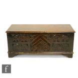 A mid 20th Century oak coffer or blanket chest of small proportions, with a hinged lid above the