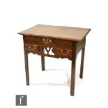 A George III and later converted oak lowboy, pierced apron with heart design flanked by two