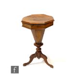 A Victorian walnut work or sewing table of tapered octagonal form, the hinged top enclosing a fitted