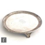 A Victorian hallmarked silver circular card waiter, plain body with raised beaded and harebell