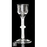 An 18th Century drinking glass circa 1760, the ogee bowl above a multi spiral opaque twist stem with