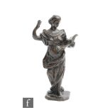 A 19th Century bronze of a Romanesque figure lecturing from an open book, standing on a square