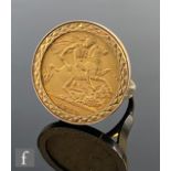 A 9ct hallmarked half sovereign ring set with a George V coin dated 1913, to plain shoulders,