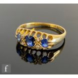 An early 20th Century 18ct sapphire and diamond seven stone ring, three oval sapphires spaced by