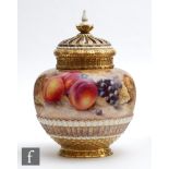 A later 20th Century Royal Worcester Fallen Fruits pot pourri vase and crown cover decorated in
