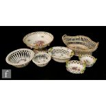 Seven assorted baskets of varying form and size, each with floral decoration comprising three Herend
