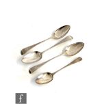 A pair of George III hallmarked silver old English pattern table spoons, London 1788, with two other