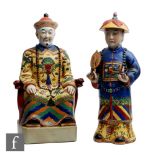 Two Chinese enamelled pottery figures modelled as a seated emperor on a throne and wearing dragon