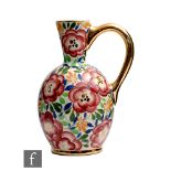 A 1930s Art Deco Boch Freres jug decorated with hand painted flowers and foliage with gilt