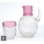 A late 19th Century Stourbridge glass water jug of footed ovoid form with collar neck decorated with
