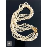 A modern fresh water pearl seven strand twisted necklet terminating in 14ct diamond set snap, length