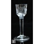 An 18th Century wine glass circa 1750, the ogee bowl engraved with a bird and flowers above a