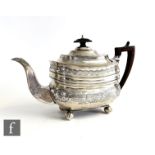 A Georgian hallmarked silver boat shaped tea pot with bright cut engraved floral decoration and