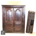 A George III oak floorstanding corner cupboard, the shaped shelf interior enclosed by a pair of arch