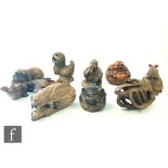 A collection of Japanese carved wooden netsuke, each modelled as a Buddha, pig, shrimp, cockerel,