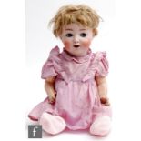 An early 20th Century German Hertel Schwab bisque socket head doll, with naughty blue eyes, open