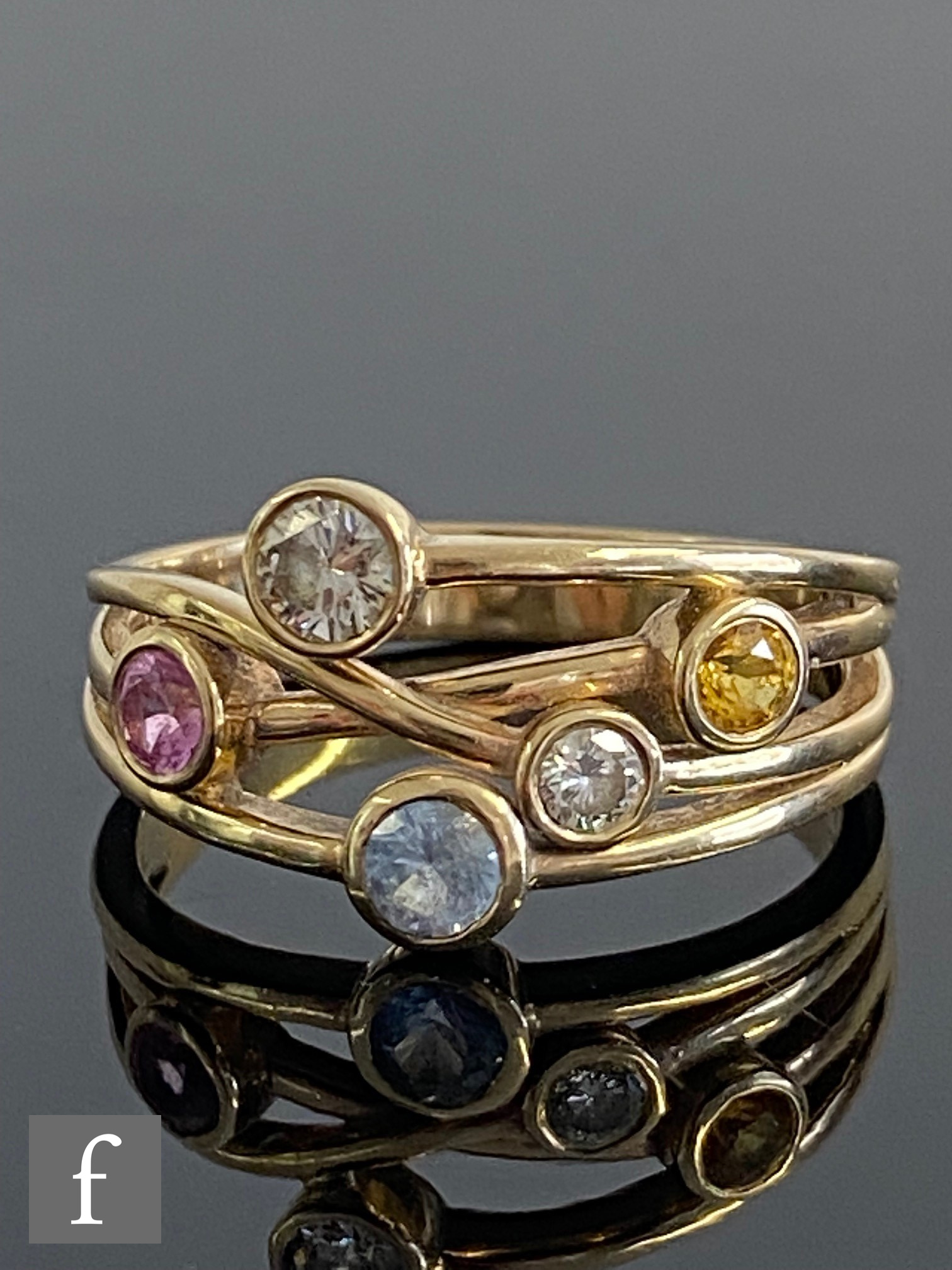 A 9ct Boodles style ring set with white, pink, yellow and blue sapphires to a spilt, cross over