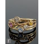 A 9ct Boodles style ring set with white, pink, yellow and blue sapphires to a spilt, cross over