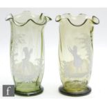 A pair of early 20th Century continental glass vases of footed swollen sleeve form with a wave