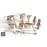 A small parcel lot of assorted hallmarked silver items, two peppers, a christening cup, a sugar