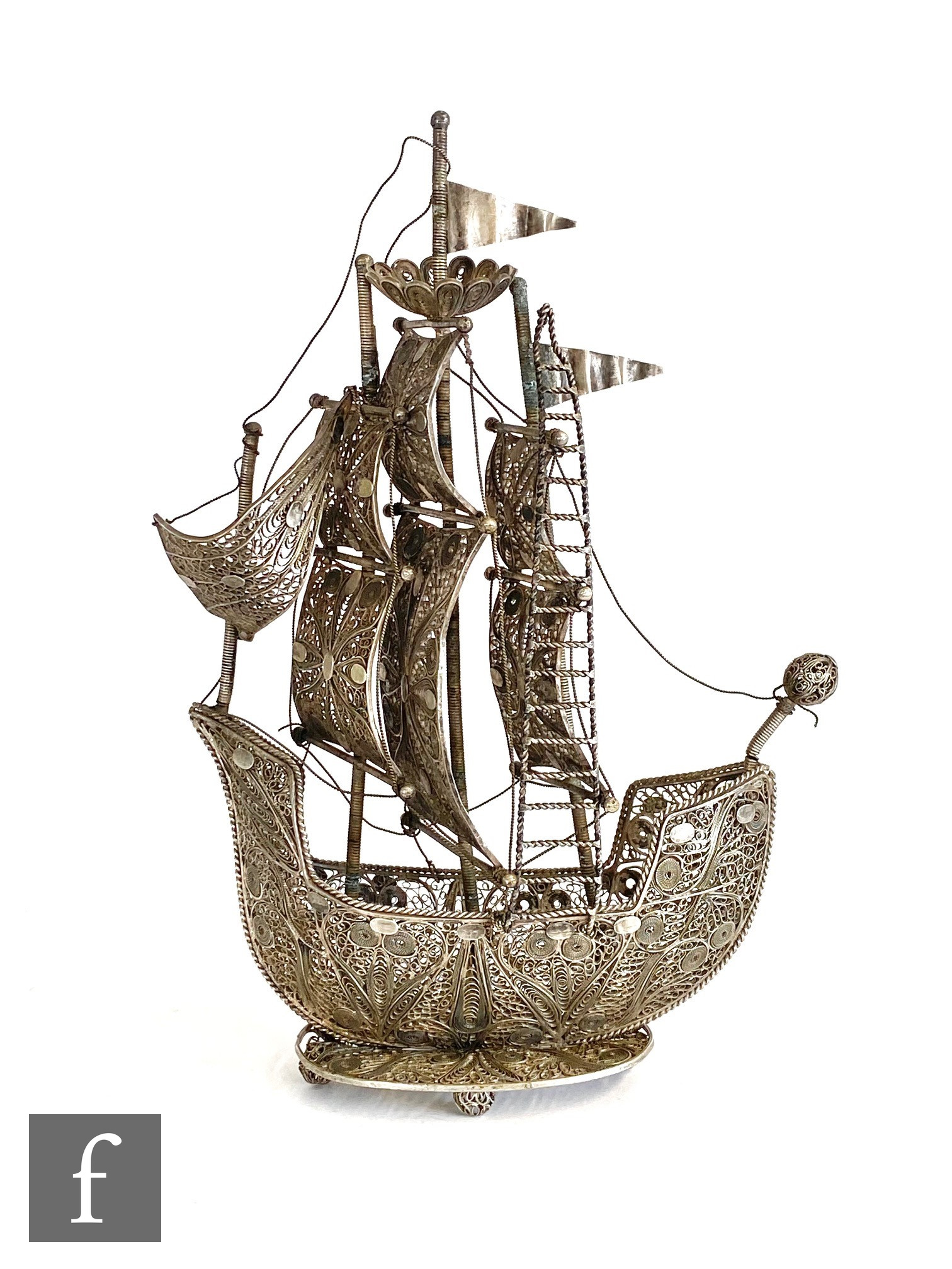 An early 20th Century continental white metal filigree work nef or study of a ship, height 23cm,