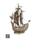 An early 20th Century continental white metal filigree work nef or study of a ship, height 23cm,